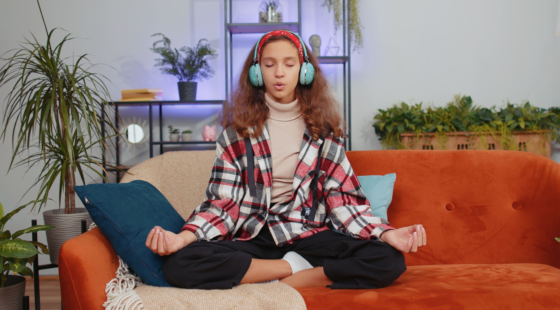 Girl child kid in headphones listening music, meditating with concentrated thoughts, peaceful mind